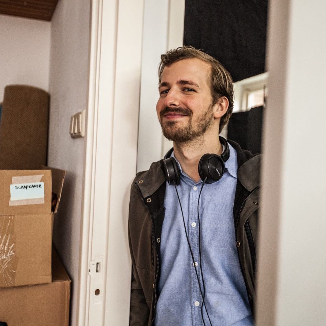 Creative professional with headphones in a modern office setting.