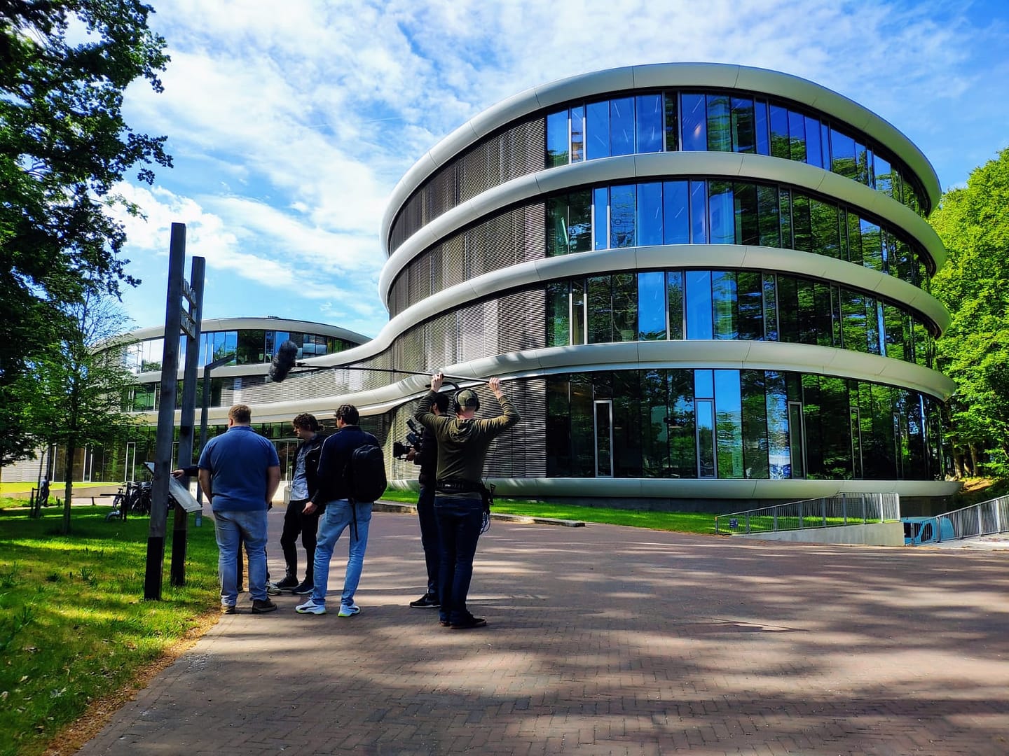 Contemporary office building with curved glass facade and sleek design.