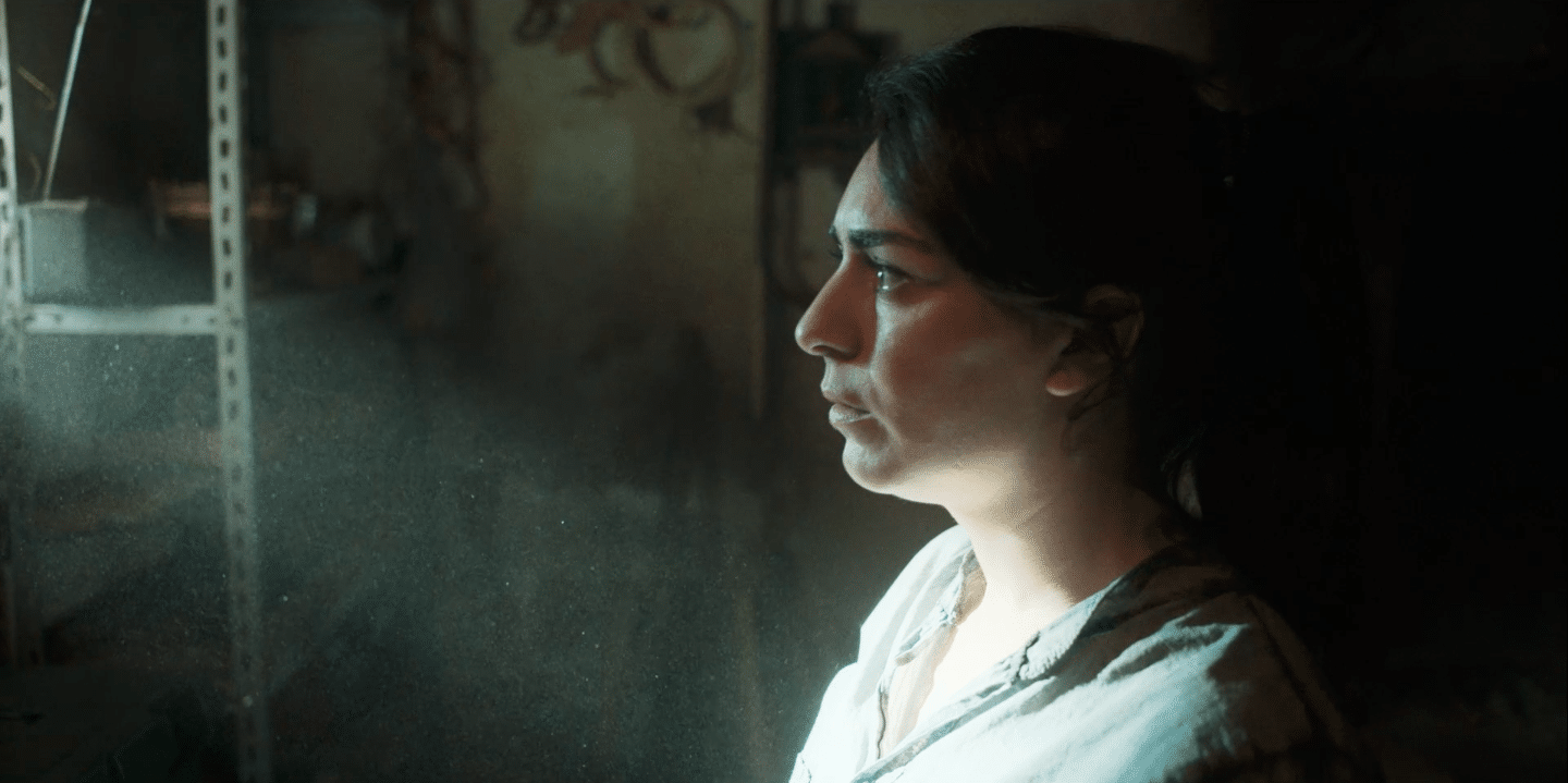 Woman working in a creative video agency with focused expression and studio lighting.