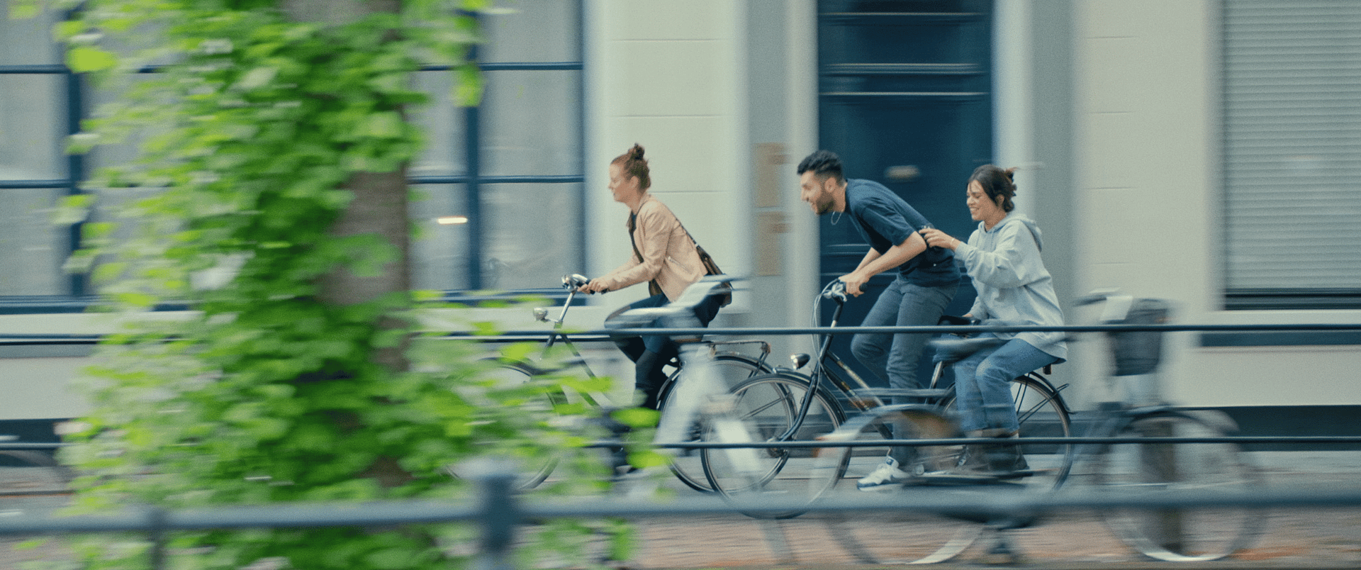 People riding bikes on city street for a creative video shoot.