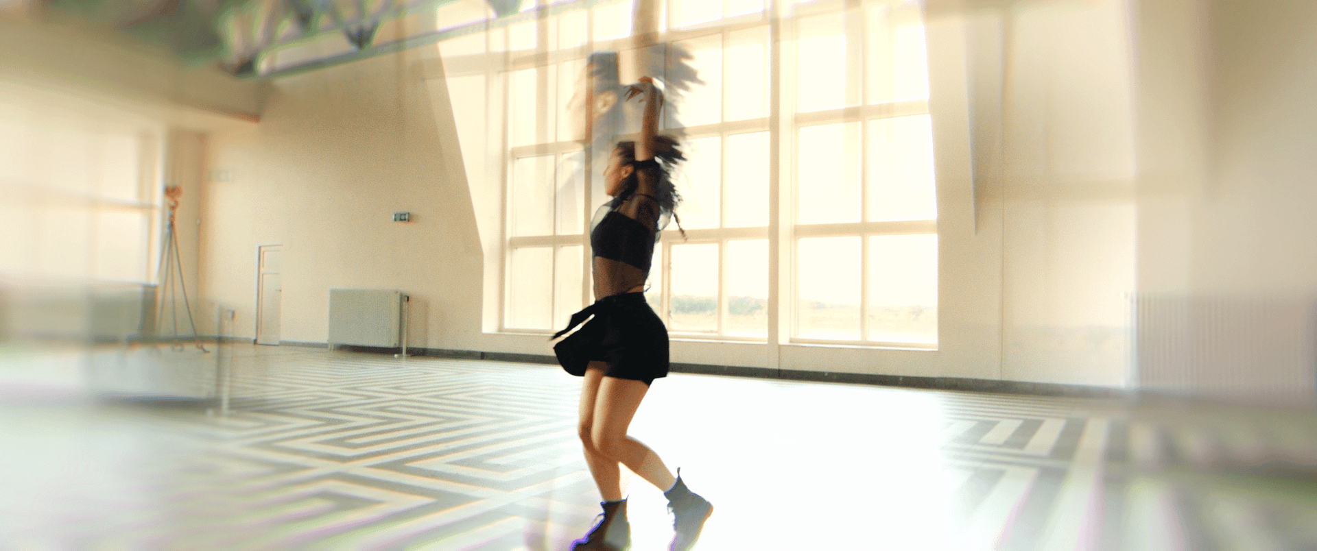 Creative dance performance in a bright studio setting.