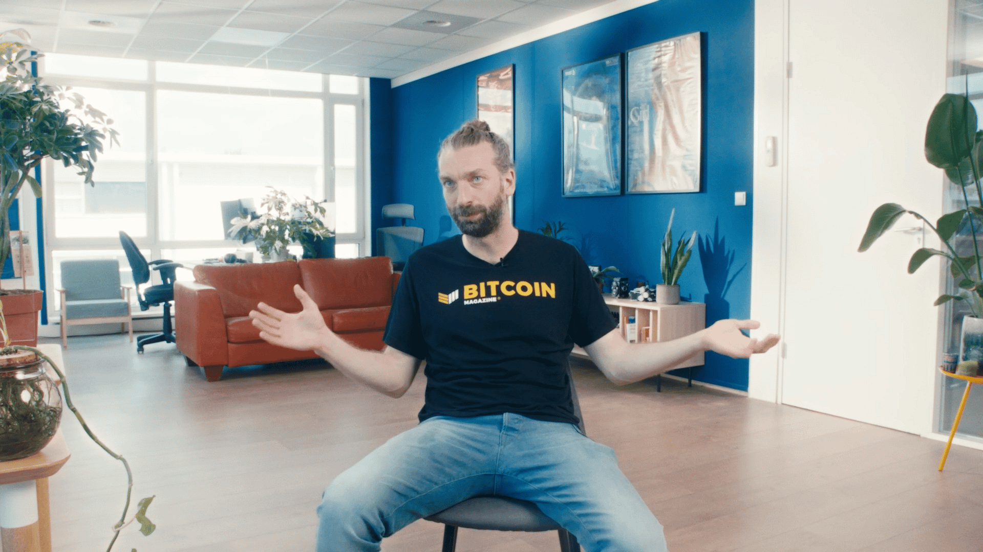 Man in a creative office with arms open, promoting video production services.