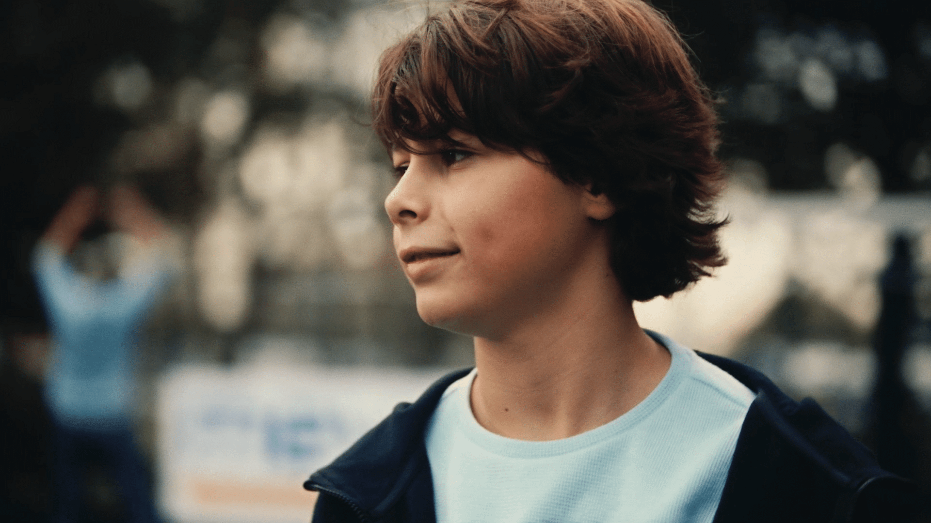 Young man with brown hair outdoors, representing creative video agency services.