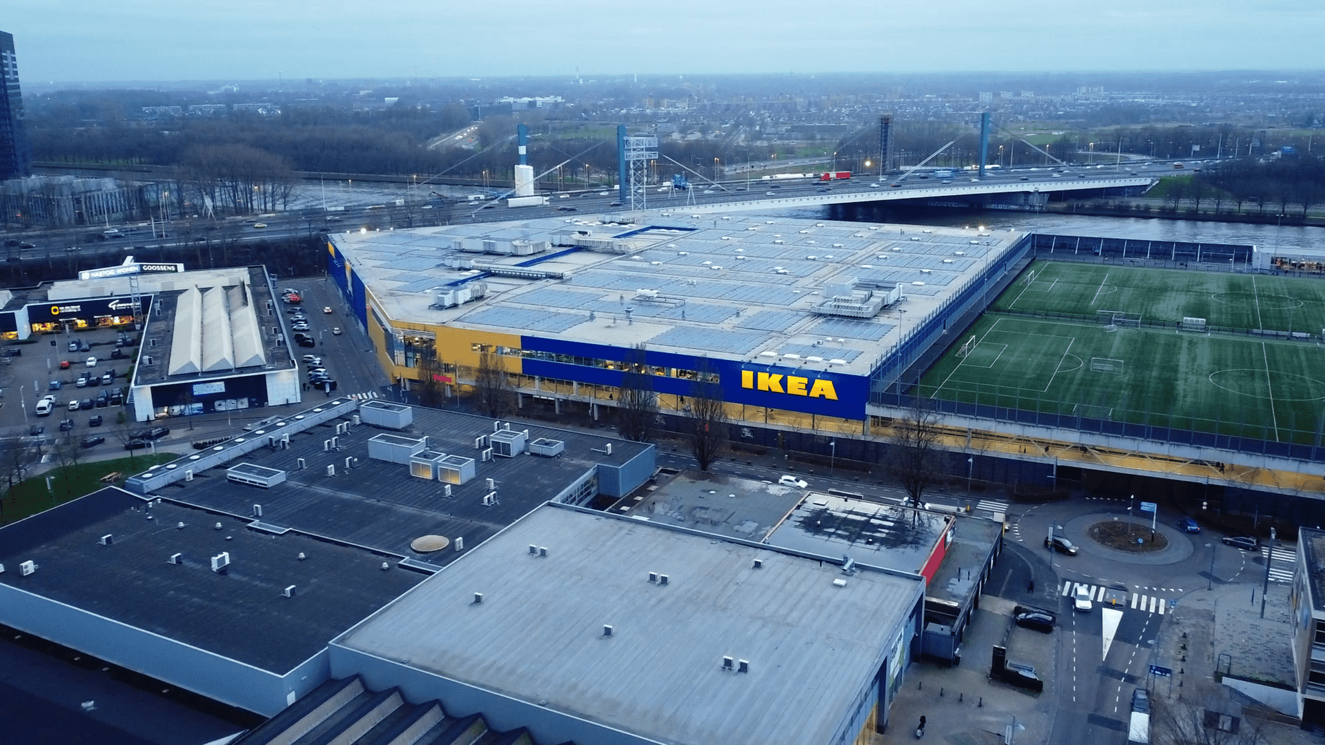 Aerial view of a large stadium with IKEA branding, parking lots, and surrounding infrastructure.