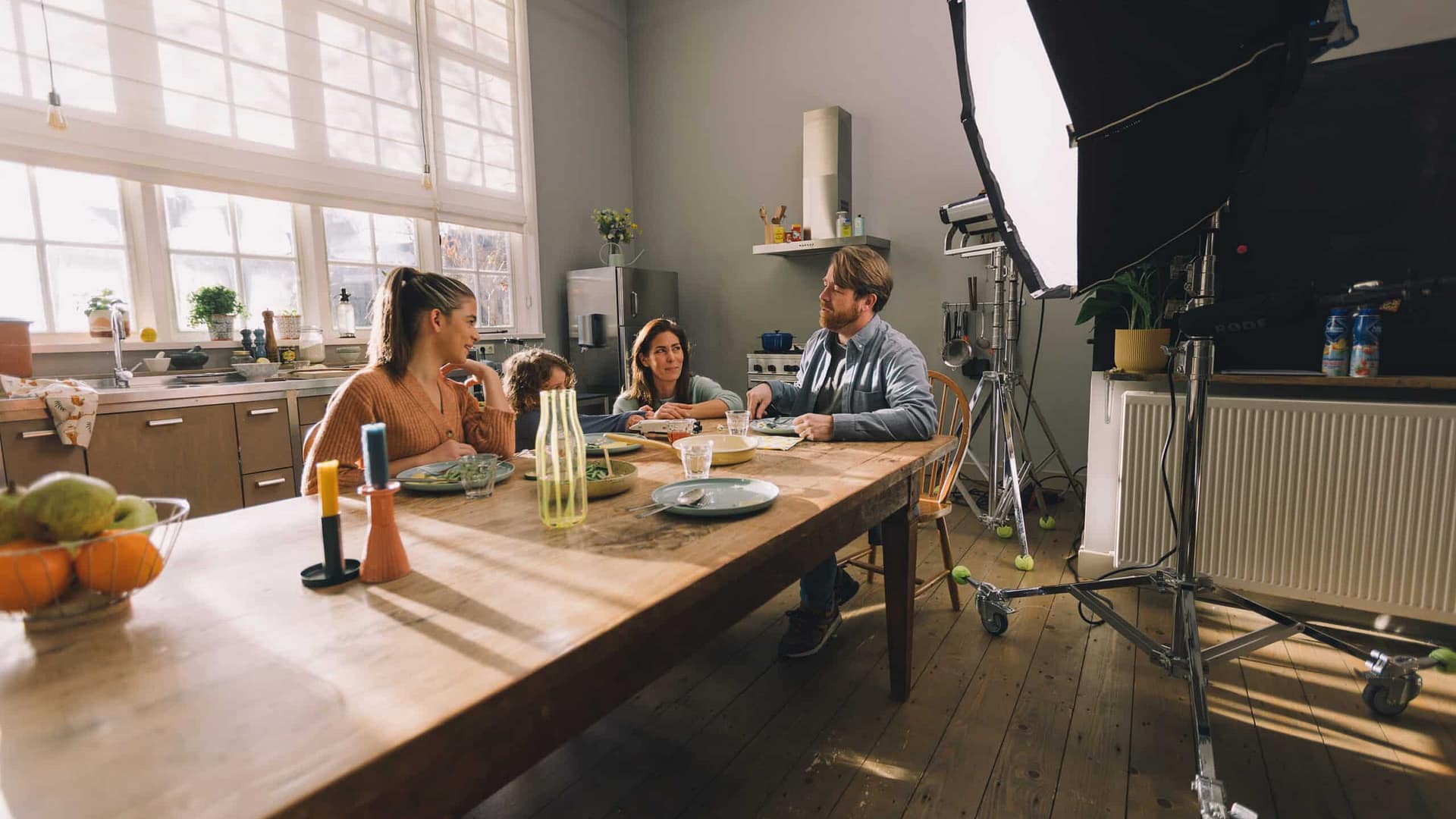 Creative video agency filming a team discussion in a well-lit studio environment.
