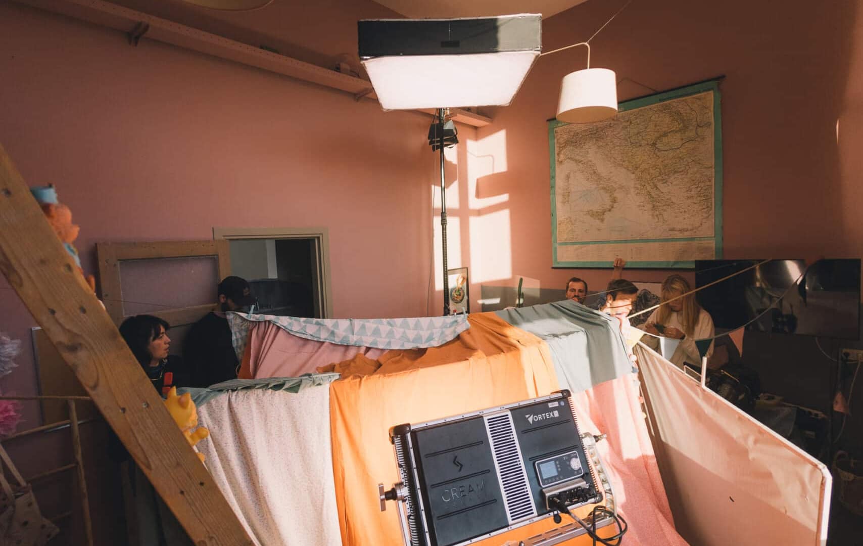 Behind-the-scenes of a creative video shoot with lighting and equipment.