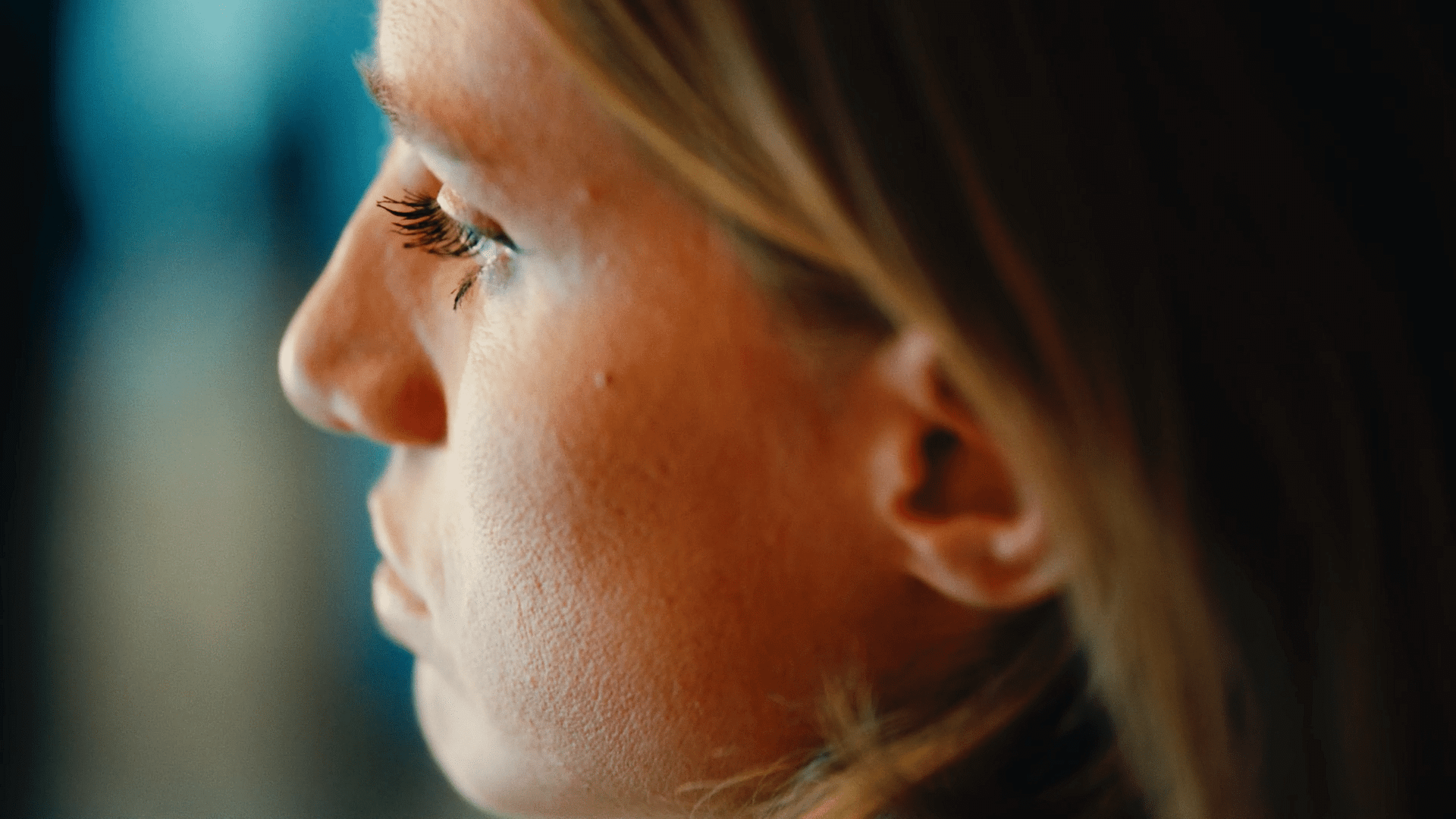 Close-up of a woman working in a creative video agency environment.