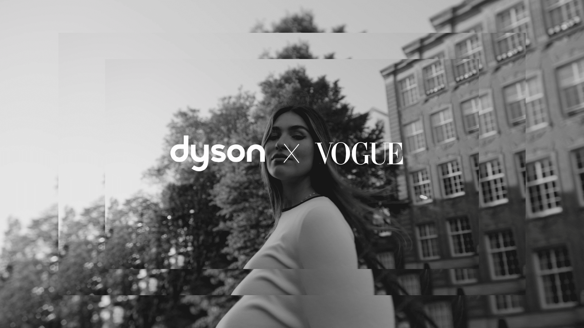 Modern woman outdoors with city buildings, representing creative video production.