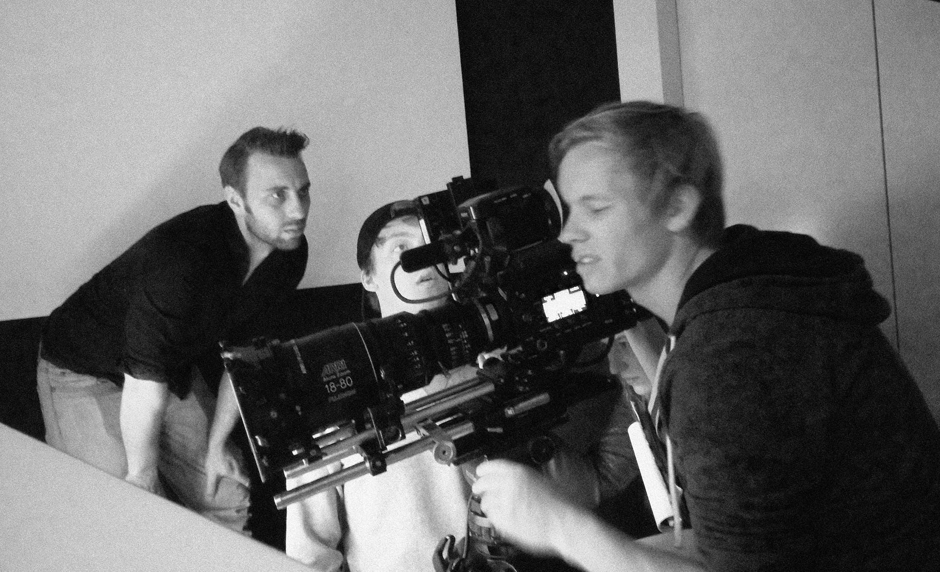Professional video production team operating camera equipment.