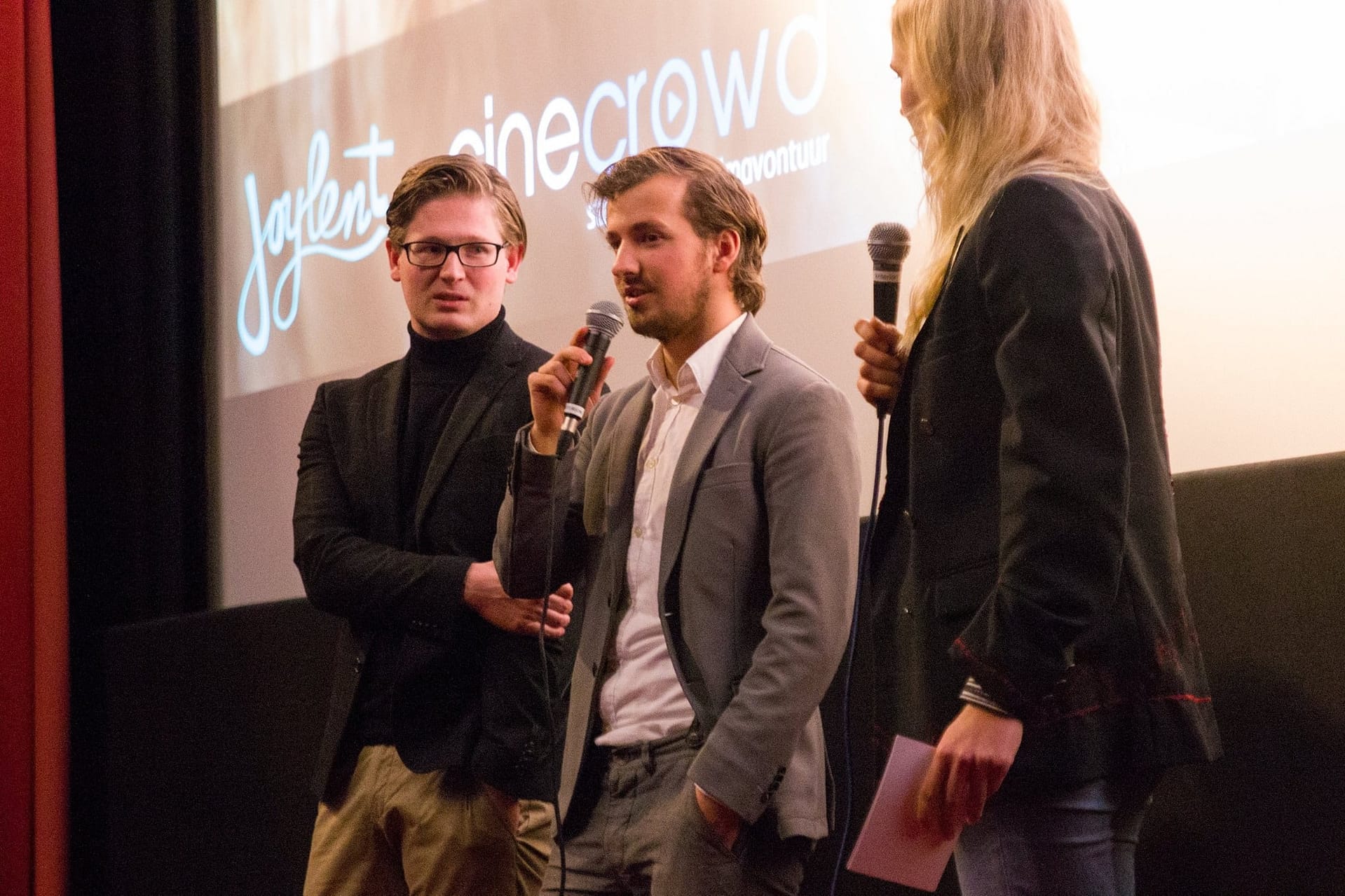 Group of professionals speaking at a conference or event.