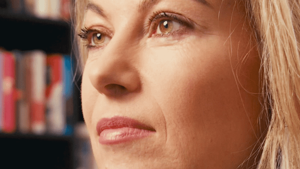 Close-up of a woman at the Royal Library, representing creative video content.