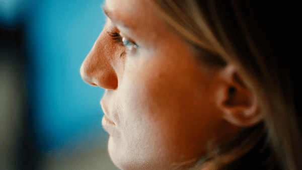 Close-up of a woman's face in profile, focused and professional.