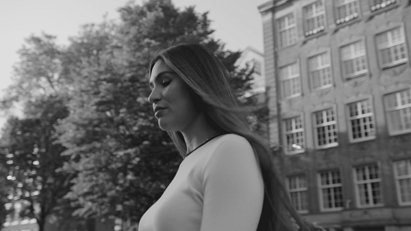 Woman with Dyson hairdryer outdoors, Vogue x Dyson campaign.