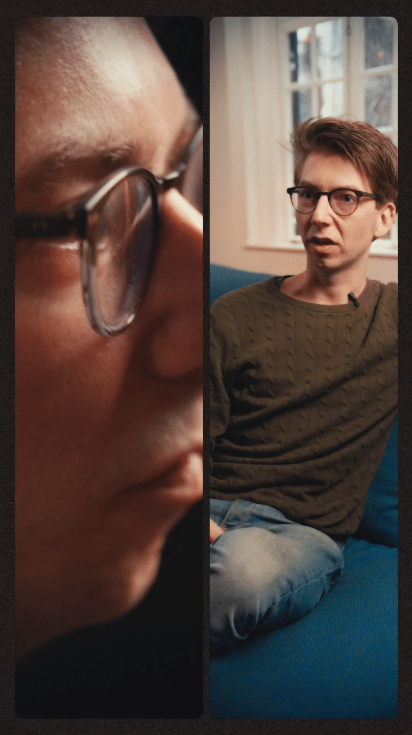 Two people in a creative discussion, one close-up and one sitting on a blue sofa.
