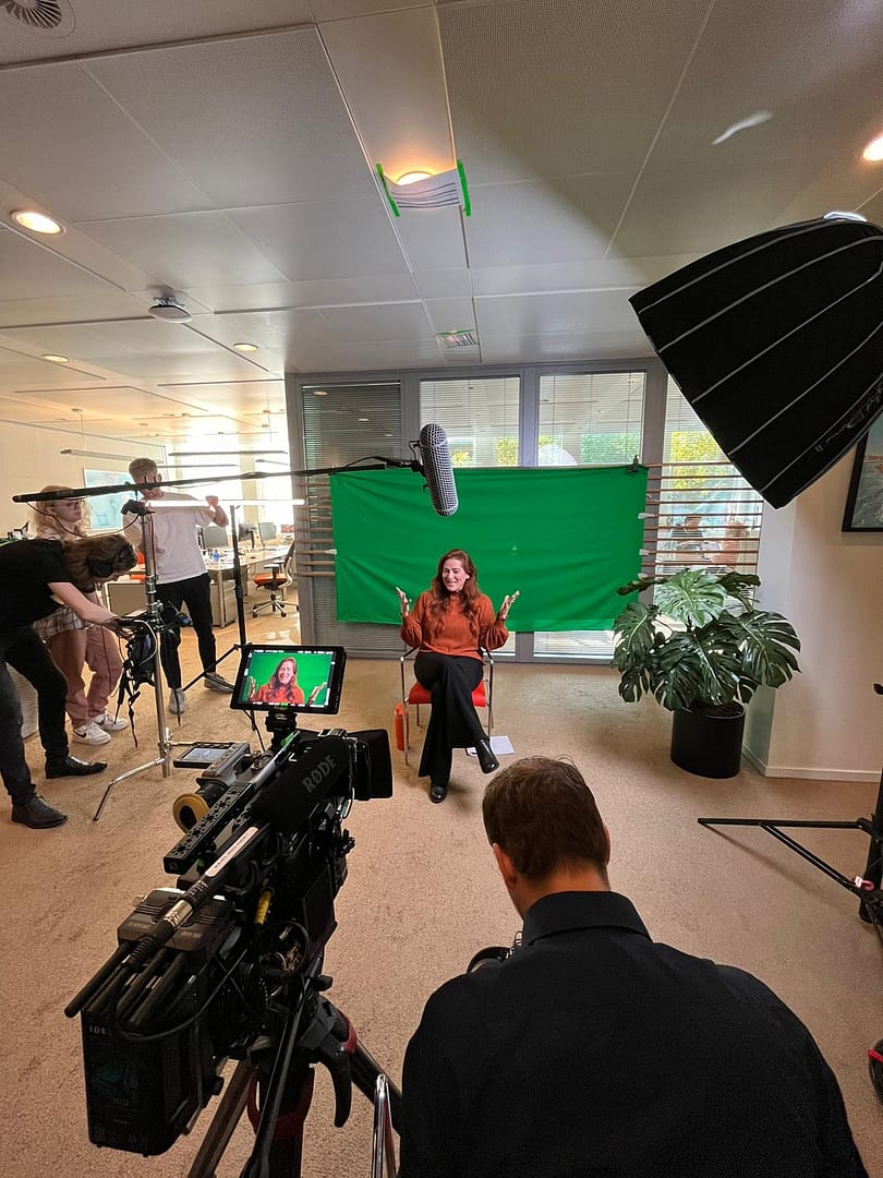 Professional video shoot with green screen setup at Waves Video Agency.
