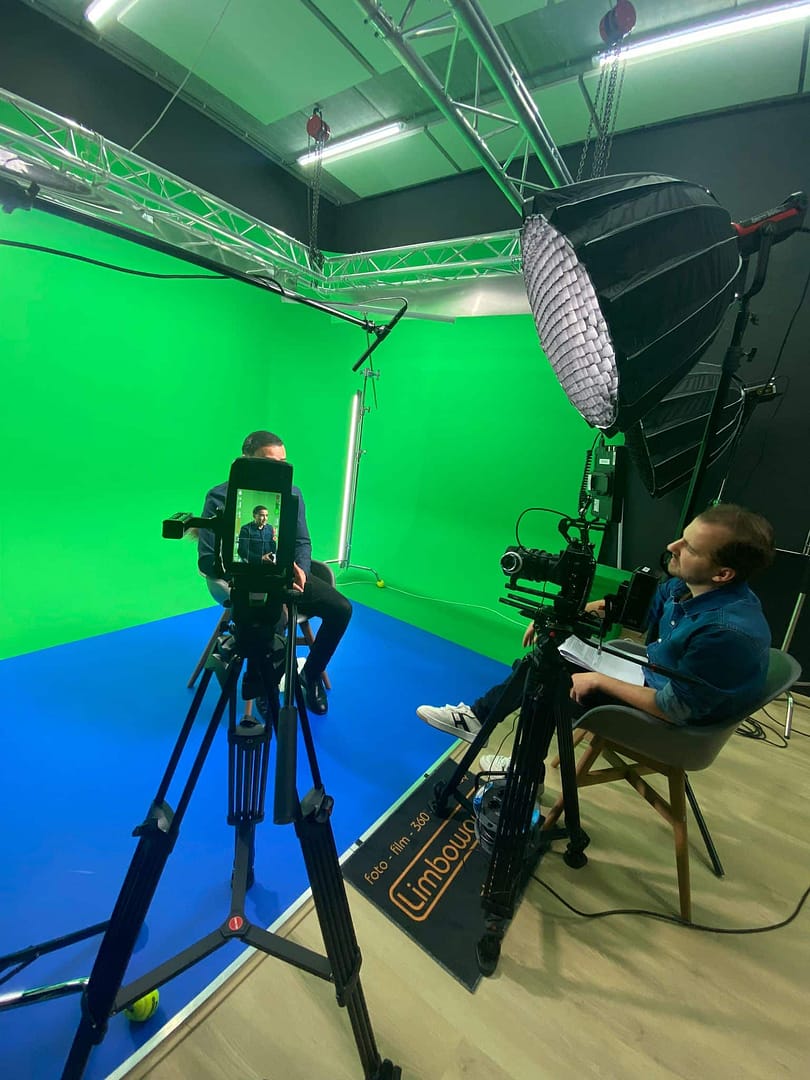Professional video studio with green screen setup for creative video production.