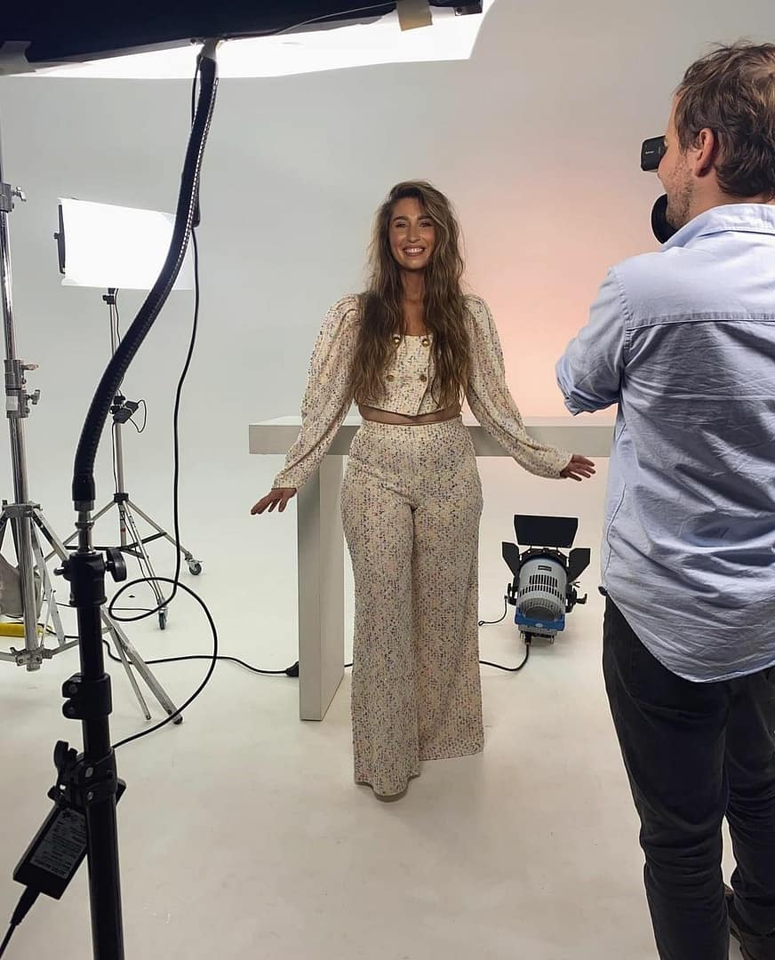 Woman in floral outfit during a professional video production.